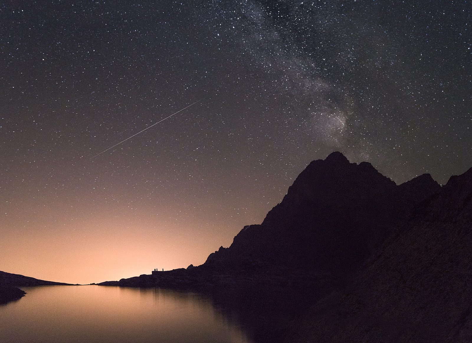 Starry night sky over mountain peaks